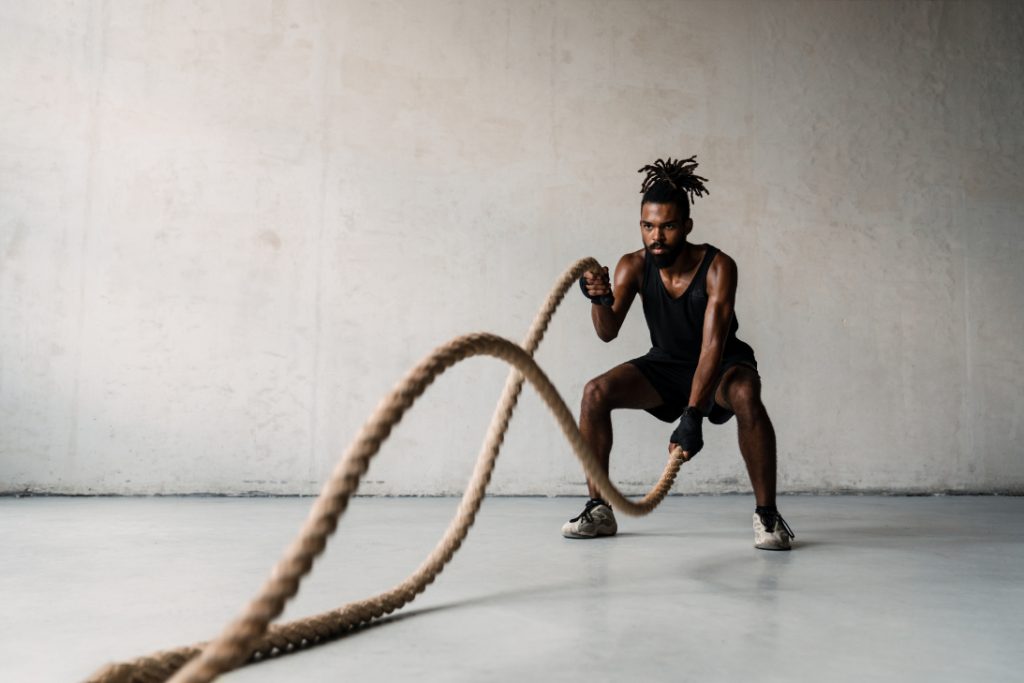 A man works out with heavy ropes