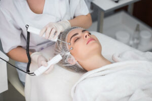 Woman receiving galvanic treatment from esthetician in medspa